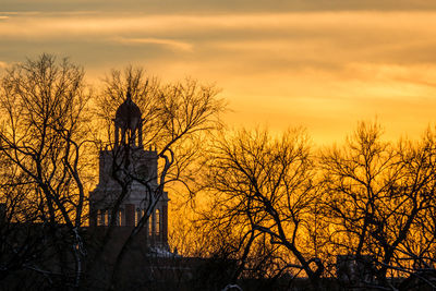 Silhouette statue against sky during sunset