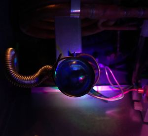 Close-up of illuminated light bulb on table