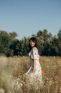 The girl is circling in the field.