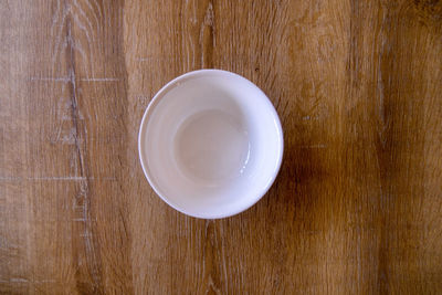 High angle view of empty tea cup on wooden table