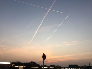 Low angle view of illuminated street light against sky