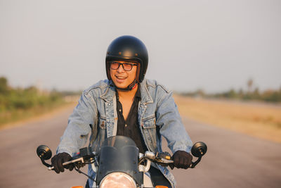 Young man riding big bike motocycle on asphalt high way against, motorbike man has freedom