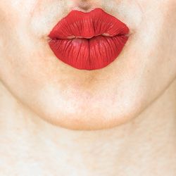 Close-up of woman with red leaf