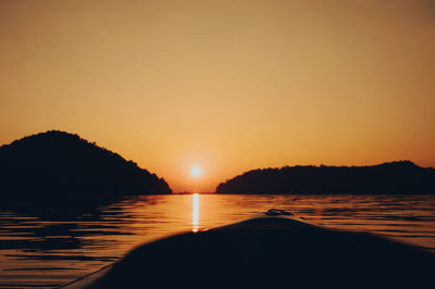 Scenic view of sea against orange sky