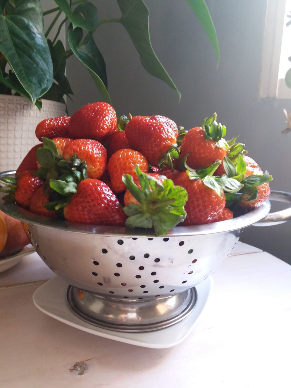 CLOSE-UP OF STRAWBERRIES ON TABLE