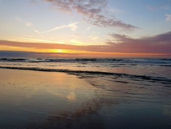 Scenic view of beach against sky during sunset