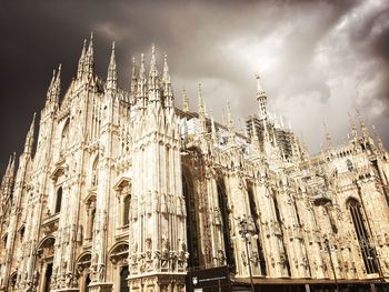 Low angle view of building against cloudy sky