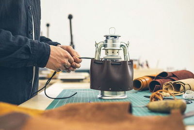 Midsection of man working on table