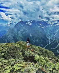 Man standing on mountain against sky