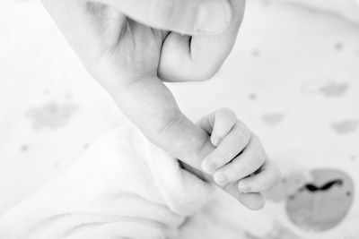 View of hands of mother and baby