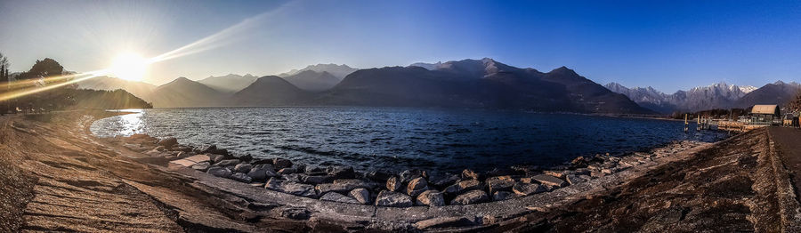 Scenic view of sea and mountains against sky