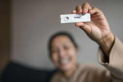 Woman holding covid-19 self test