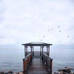 View of pier on sea against sky