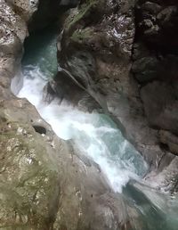 View of river flowing through rocks