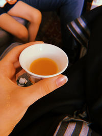 Close-up of hand holding tea cup
