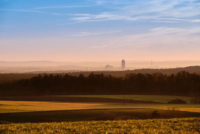 Scenic view of field against sky during sunset