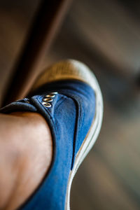 Low section of man wearing shoes