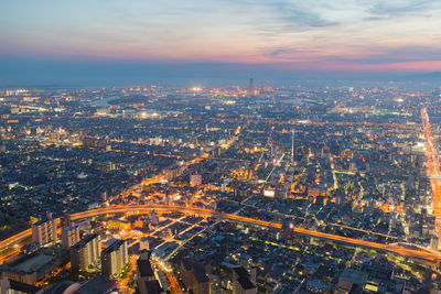 High angle view of illuminated buildings against sky during sunset