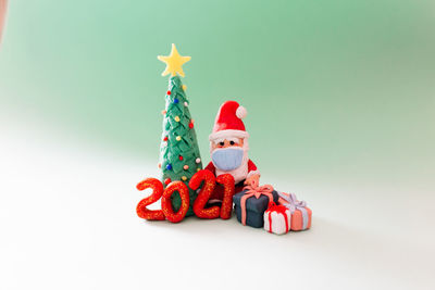 Close-up of christmas decorations against white background