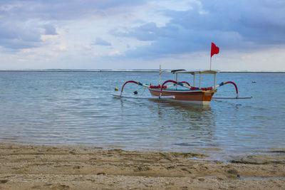 Fishing boat on sea against sky