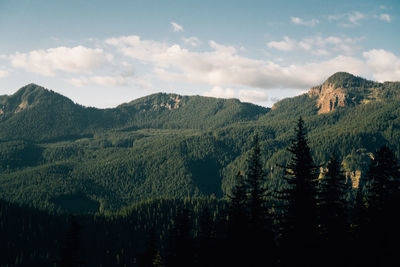 Scenic view of mountains against cloudy sky