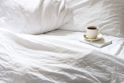 White image of bed in bedroom