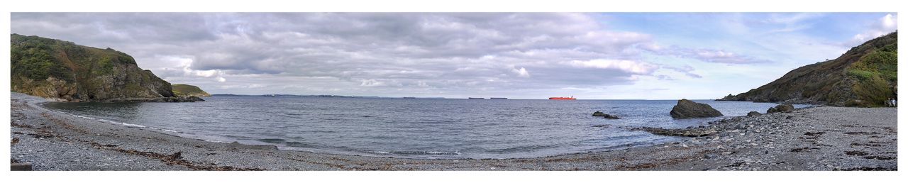 Scenic view of sea against cloudy sky