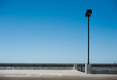 Low angle view of street light against clear blue sky