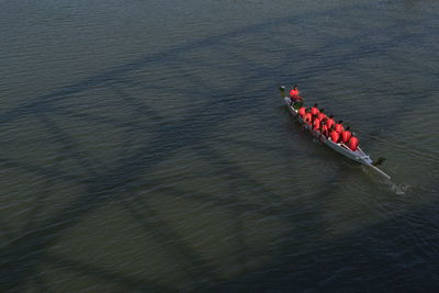 High angle view of people sitting on rowboat in river