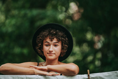 Portrait of young woman against blurred background