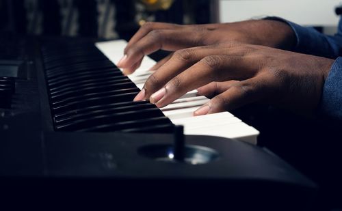 Midsection of man playing piano