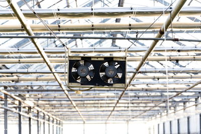 Low angle view of lighting equipment hanging on ceiling