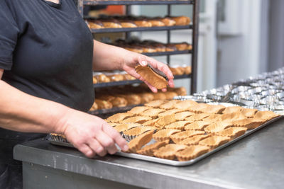 Midsection of man preparing cookies in kitchen