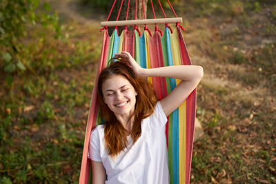 Smiling woman sitting in hammock