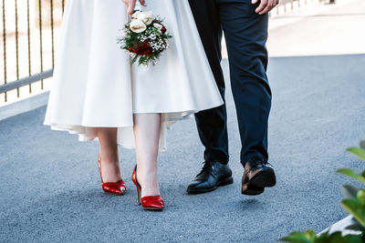 Low section of friends standing on floor