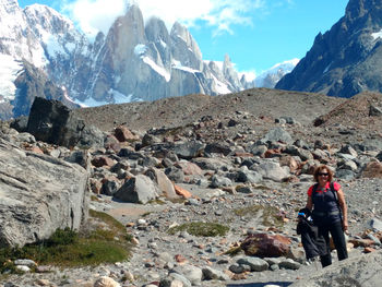 Man standing on rocks against mountains