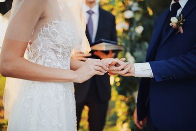 Midsection of couple during wedding ceremony