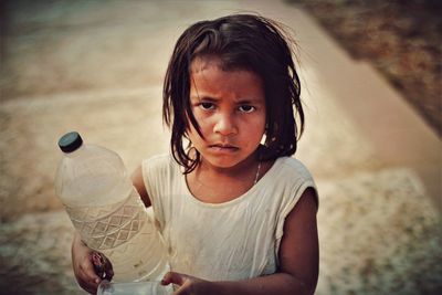 A little girl's potrait who was selling the water for her livelihood 