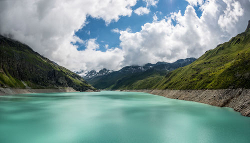 Scenic view of lake and mountains against sky