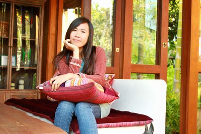 Portrait of young woman sitting outdoors