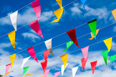 Low angle view of flag flags against sky