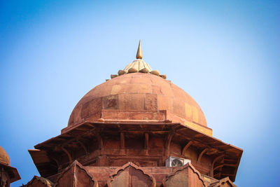 Low angle view of temple against clear blue sky