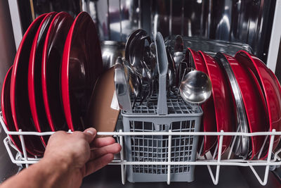 Cropped image of hand holding machine at home