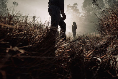 Low section of man walking on field