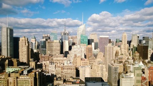 Aerial view of modern buildings in city against sky