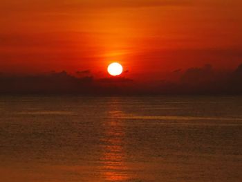 Scenic view of sea against romantic sky at sunset