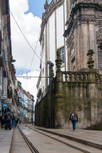 Full length of woman walking on city street