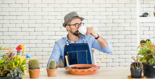 Full length of man preparing food in potted plant