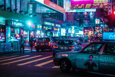 Cars on city street at night