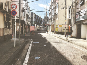 Road amidst buildings in city